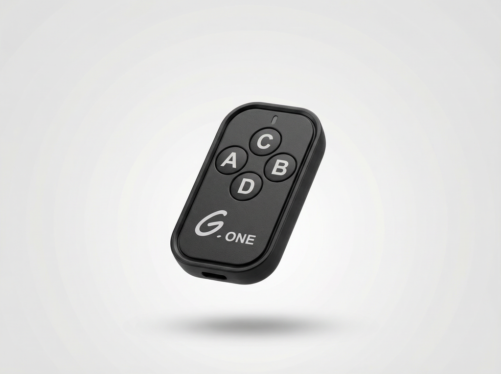 Black remote control with labeled buttons on a light gray background