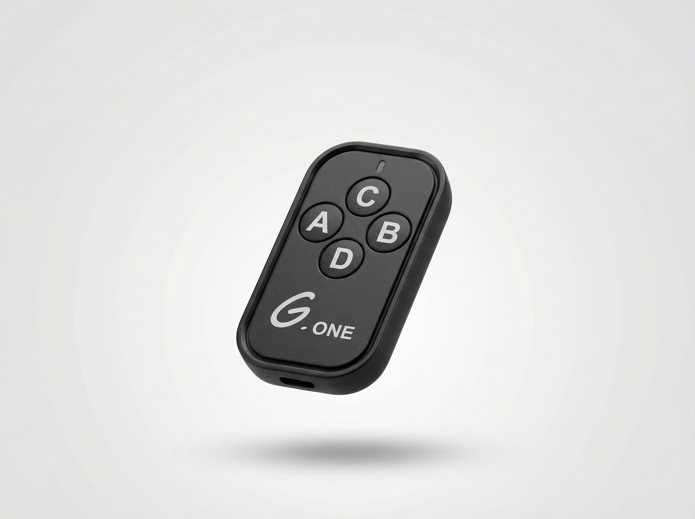 Black remote control with labeled buttons on a light gray background