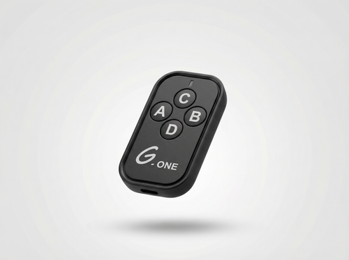 Black remote control with labeled buttons on a light gray background