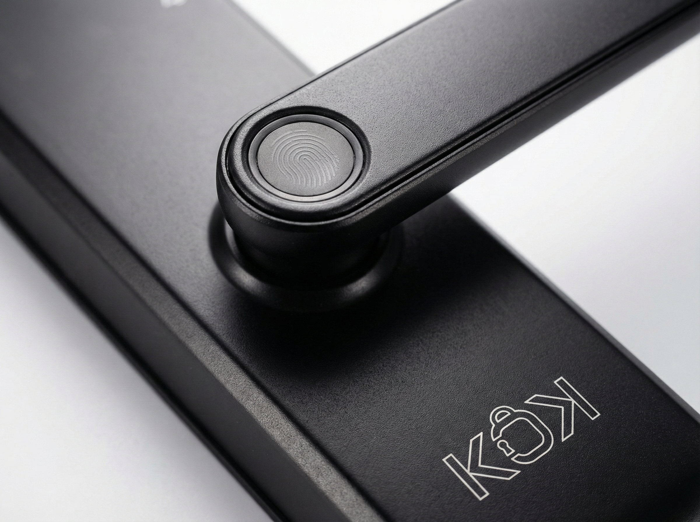 Close-up of a black door handle with fingerprint sensor on a glass door, featuring the KOKI brand.