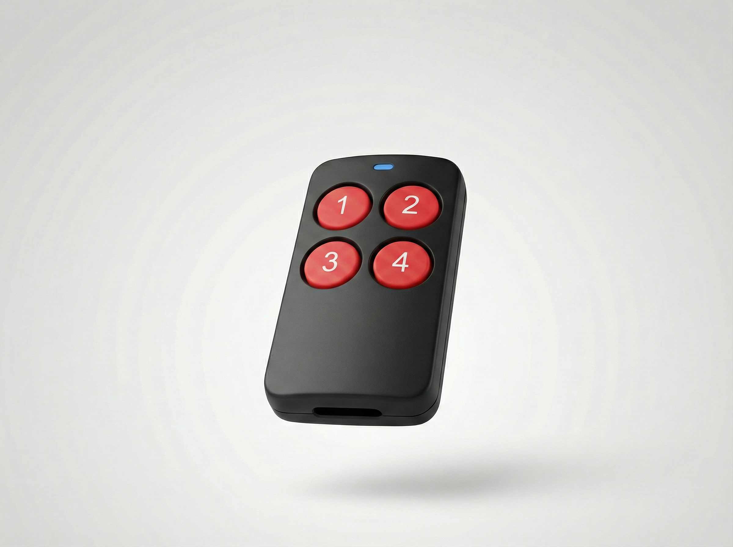 Black remote control with red buttons on a light gray background
