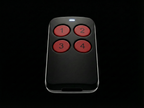Black remote control with red buttons on a black background