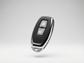 Car key fob with lock and unlock buttons on a light gray background