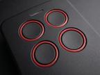 Close-up of a gaming controller with red circular buttons on a dark background
