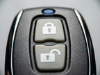 Close-up of a car key fob with lock and unlock symbols.