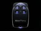 Black remote control with blue lights on a black background, branded 'Nice Flor-s'.