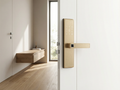 Modern door handle on a white door with a minimalistic interior design.